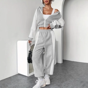 Detail of grey and white contrast stitching on the hooded sweatshirt and high-waist joggers