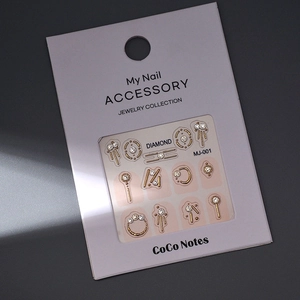 Detail of MJ-001 gold alloy nail art rhinestones with 12 elegant shapes on card
