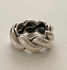 Macro shot of S925 sterling silver rope twist ring featuring vintage minimalist design