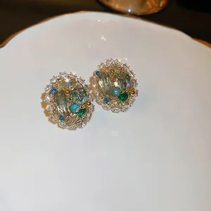 Luxurious court style oval cluster earrings with emerald green crystals and zircons