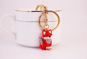 Detail of red fox keychain with gold metal clasp and sparkling crystal embellishments