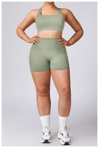 Detail of sage green workout set featuring racerback sports bra and high waist shorts