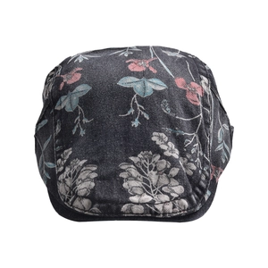 Detail of dark grey newsboy hat with colorful floral print and cotton texture