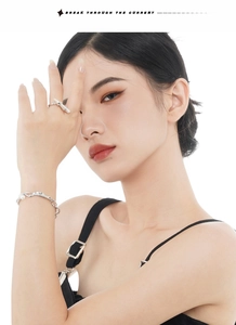 Detail view of S925 silver bracelet and pearl ring on model with clean white background