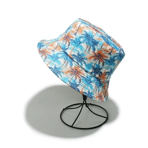 Detail of tropical palm tree print on white bucket hat for summer beach vacations