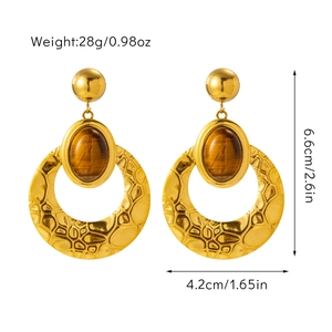 Detail view of gold hoop earrings with tiger eye inlay and dimensions 6.6cm by 4.2cm