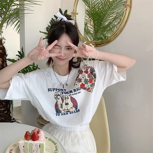 Close-up of white cotton T-shirt featuring a vintage bear graphic with colorful prints