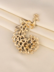 Detailed back view of golden peacock brooch showing hollow alloy craft and pin structure