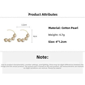 Detailed view of French vintage earrings featuring 4cm textured cotton pearls on gold wire