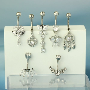Detailed close-up of silver stainless steel navel rings set with sparkling cubic zirconia