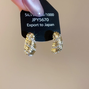 Close-up of gold-plated hoop earrings with micro-pave crystals and S925 silver posts