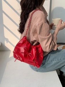 Chic red pleated PU leather shoulder bag with decorative bows and chain strap