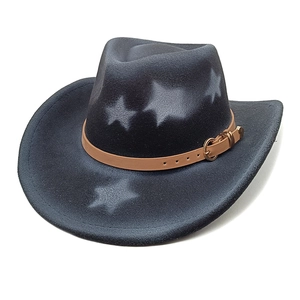 Macro detail of dark grey felt cowboy hat with star patterns and brown leather strap