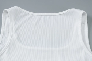 Close-up of white ribbed crop top showing the U-neckline and fine fabric texture