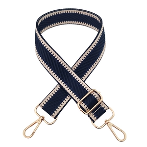 Detail of adjustable dark blue chevron woven shoulder strap with gold lobster clasps