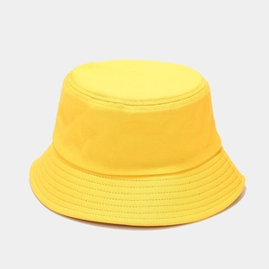 Detail of a yellow cotton sun hat with multi-row reinforced stitching on the brim