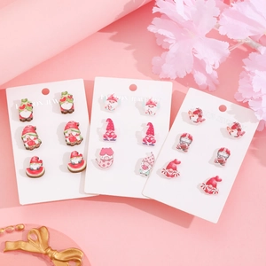 Cute acrylic earring set featuring Santa Claus, angel, and rugby themes on pink flowers