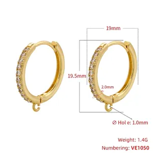 Macro shot of gold plated brass hoop earrings with single row diamonds and hanging loops