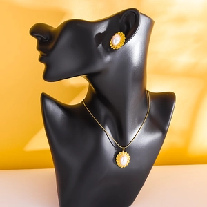 Gold plated twisted border jewelry set with white pearls and sunburst pendants on bust