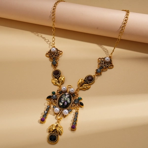 Vintage gold necklace with pearls and gemstones in a baroque style on display stands