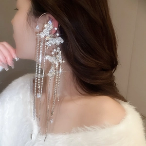 Detailed close-up of a silver butterfly tassel ear cuff with sparkling rhinestones