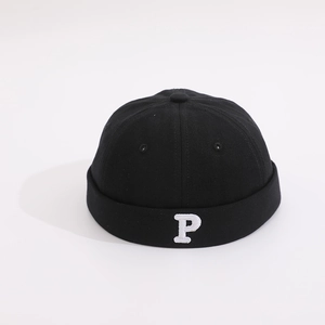 Close-up of black cotton docker hat featuring white letter P embroidery on the side