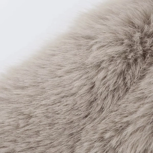 Detailed macro view of soft light brown faux fur texture for winter jackets