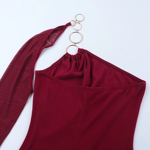 Close-up of wine red dress with metallic gold ring and sheer mesh ribbon detail