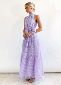 Detail of purple plaid tiered dress featuring a halter neck and adjustable waist tie