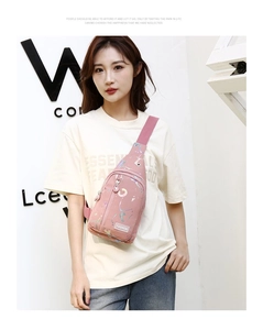 Detailed view of pink crossbody chest bag with colorful splash pattern on nylon fabric