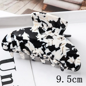 Macro shot of a 9.5cm large marble ink pattern hair claw clip made of acetate material
