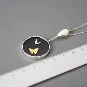 Elegant round butterfly pendant necklace in S925 silver shown with scale for size reference