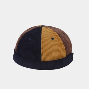 Detailed view of the tricolor corduroy texture and stitching on the brimless cap
