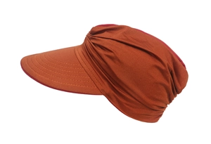 Detail view of double-sided burnt orange and red sun hat with pleated fabric texture