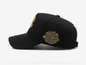 Side view of black baseball cap featuring detailed gold embroidery of wolf style logos