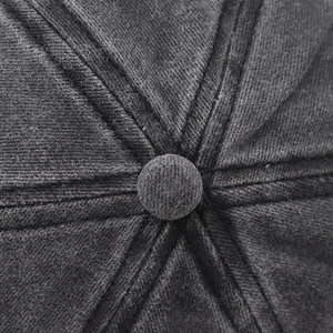 Macro detail of charcoal grey washed cotton baseball cap crown with stitched top button