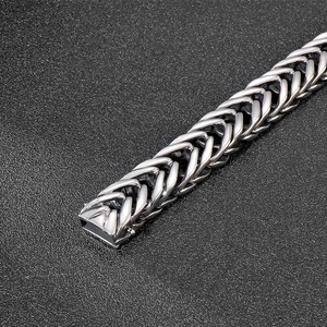 Macro detail of men's punk style V-shaped woven stainless steel chain link bracelet