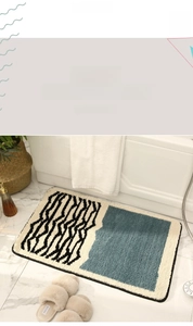 Detail of plush geometric bathroom mat with non-slip backing on marble floor