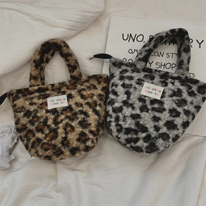 Detail of plush leopard print handbags in brown and grey with soft faux fur texture