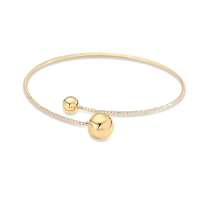 Detail of gold-plated open cuff bracelet featuring polished gold spheres and pavé zircons