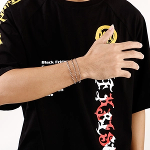 Minimalist silver multi-layer stainless steel chain bracelet worn on a person's wrist