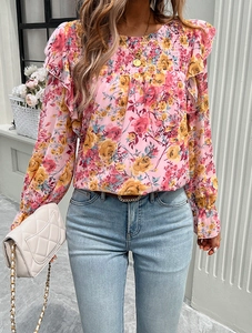 Detailed view of women's floral chiffon shirt featuring ruffled shoulders and smocked neckline