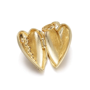 Detailed macro view of an open 18K gold heart locket pendant with sparkling rhinestones