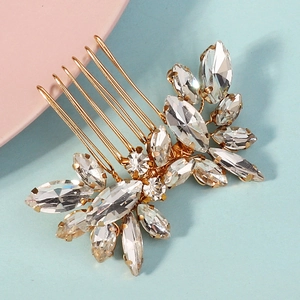 Close-up of handmade bridal hair comb with marquise rhinestones and gold finish