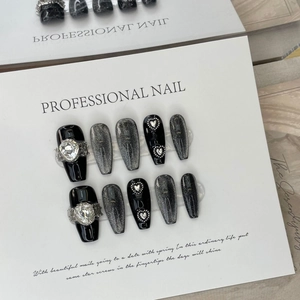 Handmade dark cat-eye press-on nails in long coffin shape with heart rhinestones and pearls