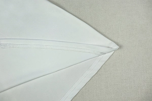 Detailed close-up showing high-quality overlock stitching and grey fabric texture