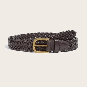 Vintage dark brown woven leather belt with antique brass square buckle on beige background