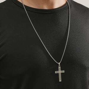 Luminous stainless steel cross pendant necklace for men worn on a black t-shirt