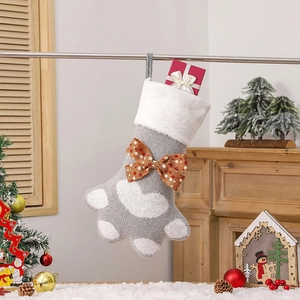 Gros plan sur une chaussette de Noël en tricot gris avec nœud orange à pois