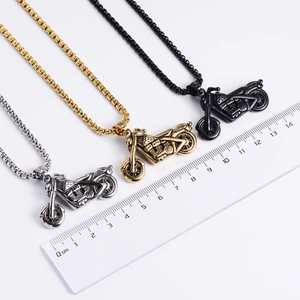 Three motorcycle necklaces in silver, gold, and black finish with scale for size reference